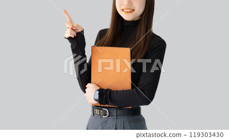 A woman/businesswoman pointing with her index finger up 119303430