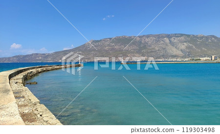 A large, expansive body of water with majestic mountains in the background A large, expansive body of water with majestic mountains in the background 119303498
