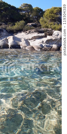 Azure Aegean sea view. Vourvourou village, Diaporos island. North Greece 119304389