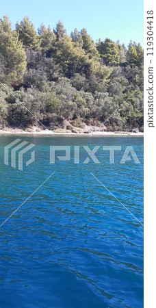 Azure Aegean sea view. Vourvourou village, Diaporos island. North Greece 119304418