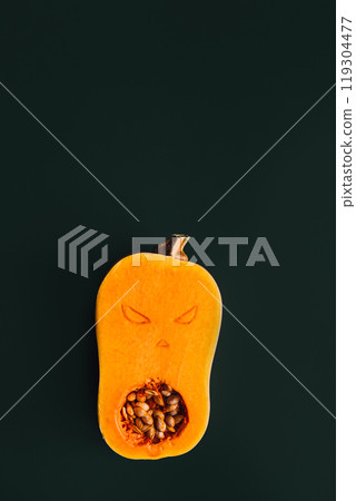 Butternut squash carved with spooky face, showcasing creative Halloween decoration ideas Butternut squash carved with spooky face, showcasing creative Halloween decoration ideas 119304477