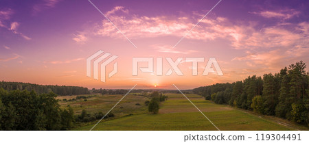 Rural landscape in the evening with the beautiful burning sky. Aerial view. Panoramic view of pine forest, and fields during sunset. Horizontal banner 119304491