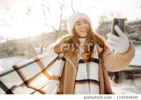 Young woman taking selfie in winter street. Holidays, rest, blogging. 119304600