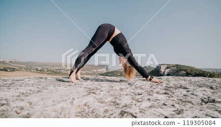 Woman Practicing Yoga on a Clifftop with Mountain Views 119305084