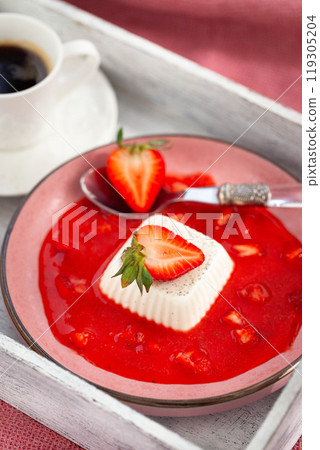 Delicious Italian dessert Panna Cotta with strawberry sauce and fresh berries 119305204
