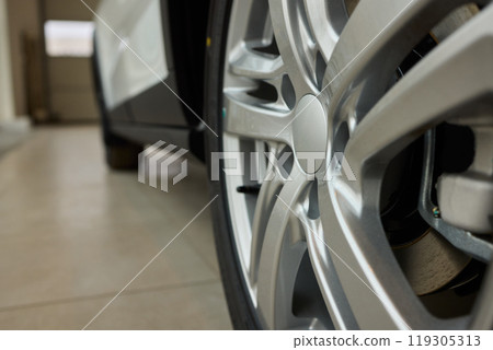 Detailed shot of a sleek black and silver alloy wheel on a motor vehicle Detailed shot of a sleek black and silver alloy wheel on a motor vehicle 119305313