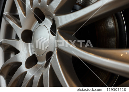 Detailed shot of a sleek black and silver alloy wheel on a motor vehicle Detailed shot of a sleek black and silver alloy wheel on a motor vehicle 119305318
