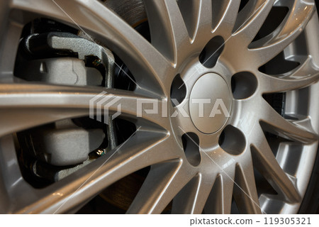 Detailed shot of a sleek black and silver alloy wheel on a motor vehicle 119305321