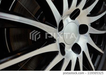 Detailed shot of a sleek black and silver alloy wheel on a motor vehicle Detailed shot of a sleek black and silver alloy wheel on a motor vehicle 119305325