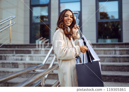 Young woman with shopping bags. Consumerism, purchases, shopping, lifestyle, sale concept. 119305861
