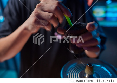 Person holding a hookah at a drinking establishment event 119306414