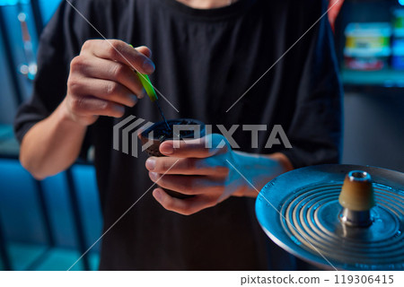 Person holding a hookah at a drinking establishment event 119306415