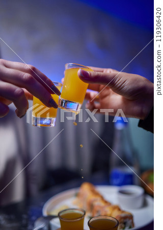 At a lively nightclub, people are enjoying wine and socializing in a chic ambiance At a lively nightclub, people are enjoying wine and socializing in a chic ambiance 119306420