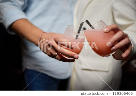 At a lively nightclub, people are enjoying wine and socializing in a chic ambiance 119306466