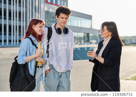 Business woman with digital tablet talking working with group of youth, outdoor Business woman with digital tablet talking working with group of youth, outdoor 119306731