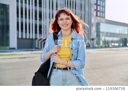 Portrait of young smiling female college student with backpack, city background Portrait of young smiling female college student with backpack, city background 119306738