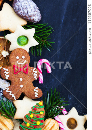 Gingerbread man and different sweet Christmas cookies, close-up, top view 119307008