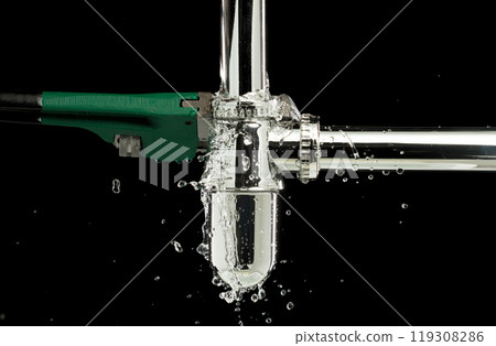Heavy Duty Wrench fix Water leak under sink. Drain sink leak water from pipe hose plumbing in bathroom and repair by wrench tools as water splash drop. Black background isolated Heavy Duty Wrench fix Water leak under sink. Drain sink leak water from pipe hose plumbing in bathroom and repair by wrench tools as water splash drop. Black background isolated 119308286