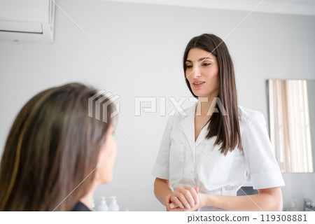 Female dermatologist discussing with anonymous 119308881