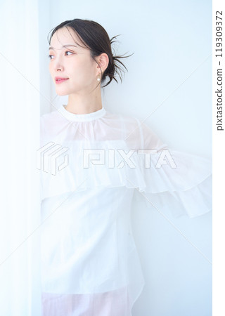 Woman in white image Woman in white image 119309372