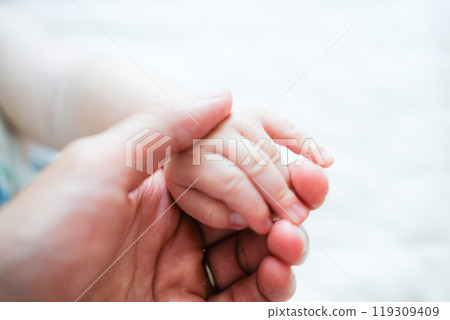 Baby and dad's hand 119309409