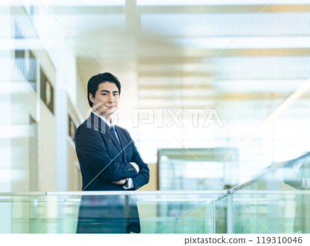 A businessman standing in the office 119310046