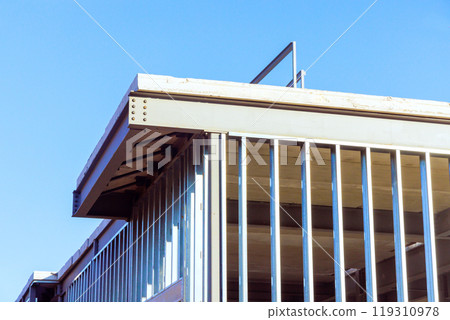 Under construction, steel beams frame frame of an office building 119310978