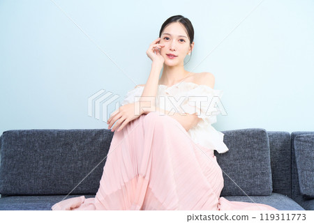 A woman sitting on a sofa 119311773