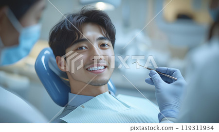 Man being treated by dentist 119311934