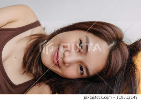 Close up of happy woman selfie herself enjoy relaxing on the sofa and pillow. Close up of happy woman selfie herself enjoy relaxing on the sofa and pillow. 119312142