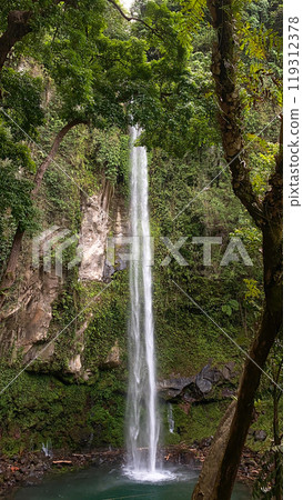 Beautiful view of water flowing down in Camiguin Island. Katibawasan Falls. Philippines. 119312378