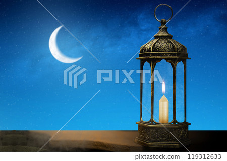 Ornamental arabic lantern with burning candle and crescent moon on the night sky. Muslim holiday decoration Ornamental arabic lantern with burning candle and crescent moon on the night sky. Muslim holiday decoration 119312633
