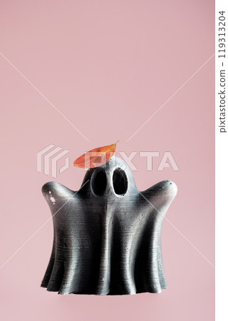 Ghost figure topped with autumn colored leaf. Artistry and seasonal themes. 119313204