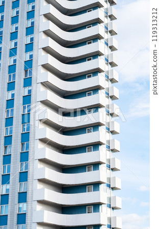 Modern apartment building featuring unique balconies. 119313212
