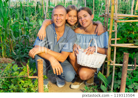 Portrait of family with their little daughter at their farm field Portrait of family with their little daughter at their farm field 119313504