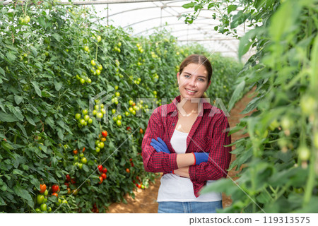 Young lady standing inside big orchard 119313575