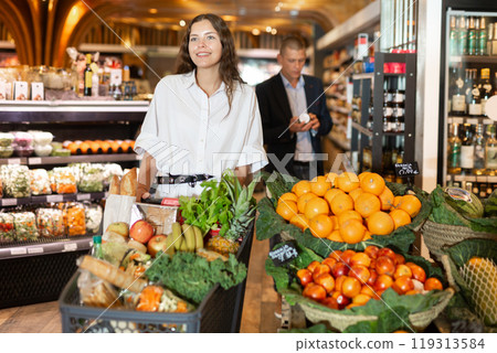 Woman shopping at grocery department at supermarket Woman shopping at grocery department at supermarket 119313584
