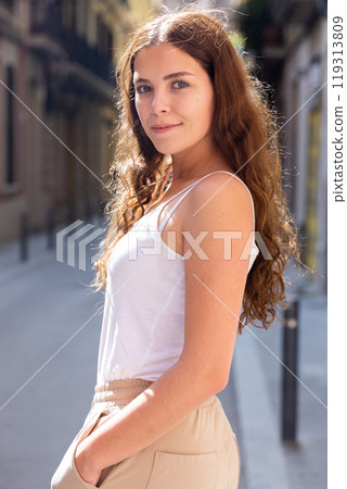 Cheerful attractive female walking on street outdoor 119313809
