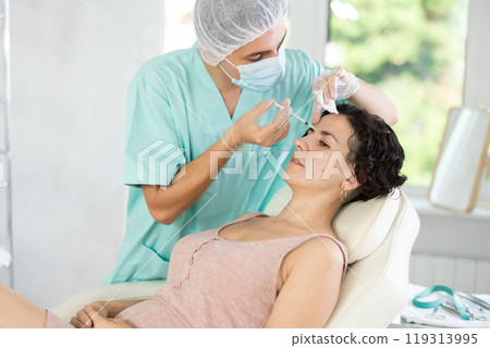 Facial injection female patient 119313995