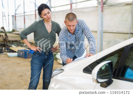 Two people with documents 119314172
