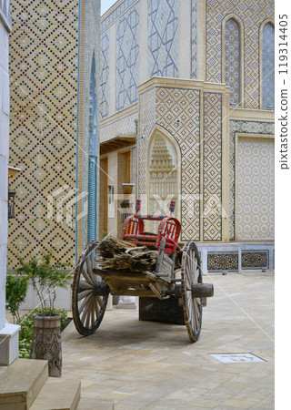 Handmade wooden cots for children on cart among decorated buildings in Samarkand, Uzbekistan 119314405