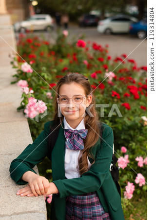 Girl in school uniform smiling confidently 119314804
