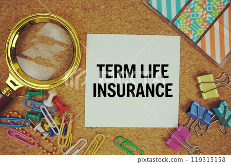 Term Life Insurance text on paper card with magnifying glass and stationery on cork board background 119315158