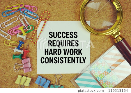 Success Requires Hard Work Consistently text on paper card with magnifying glass and stationery on cork board background 119315164