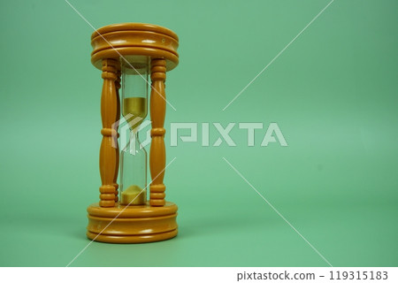 Hourglass with space for text on green background Hourglass with space for text on green background 119315183