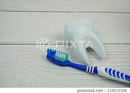 Toothbrush and Tooth dental hygiene concept top view on wooden background Toothbrush and Tooth dental hygiene concept top view on wooden background 119315506