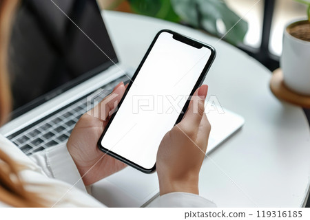 Mockup blank white screen mobile phone. Woman sitting at table in cafe, using empty screen smartphone. template for display your product advertisement, mobile app design 119316185
