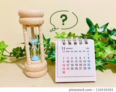 November desk calendar and hourglass 119316383
