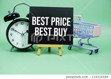 Best Price Best Buy text message on paper card with alarm clcok and trolley shopping cart on green background 119316564