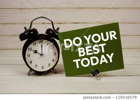 Do Your Best Today text message on paper card with alarm clcok on wooden background 119316579